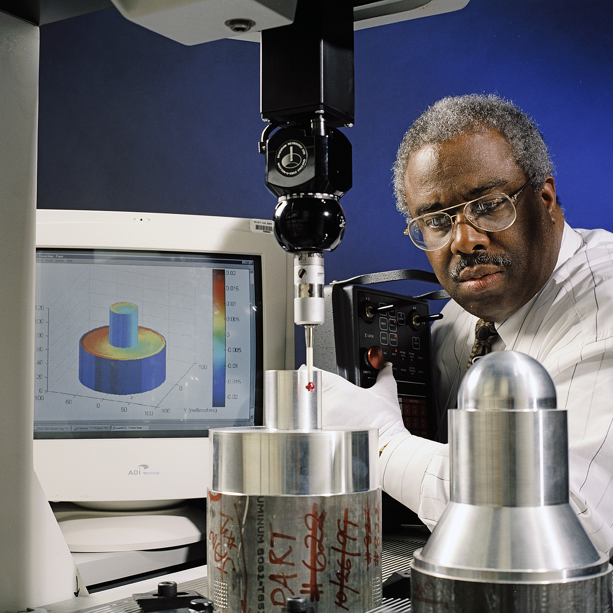 Quality inspector measuring precision parts with a coordinate measuring machine